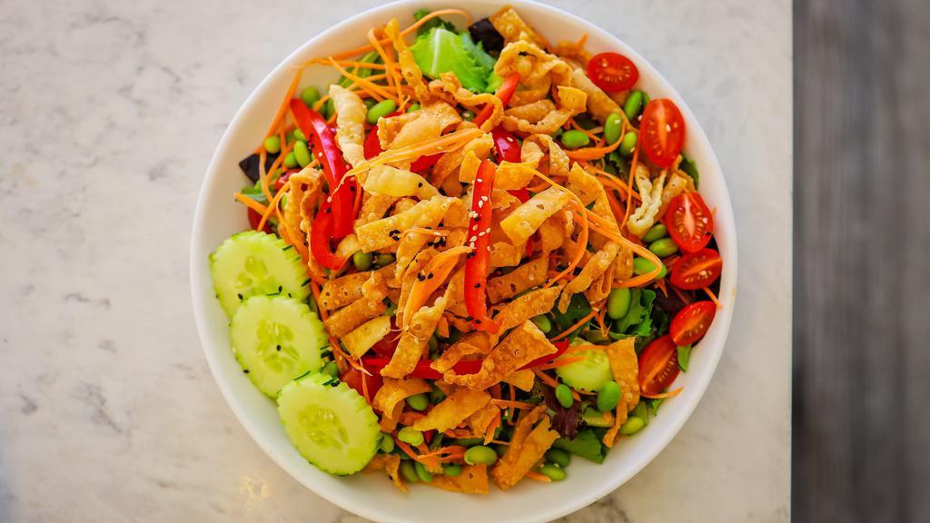Thai Joint Salad · Edamame, cucumbers, red bell pepper, shredded carrot, cherry tomatoes, spring mix, romain lettuce, sesame seeds, and crispy wonton strips. Served with your choice of Thai peanut dressing or fresh ginger dressing.