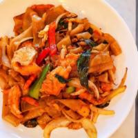 Drunken Noodles · Wide rice noodle sautéed with egg in a mixture of onions, bell peppers, carrots, and fresh b...