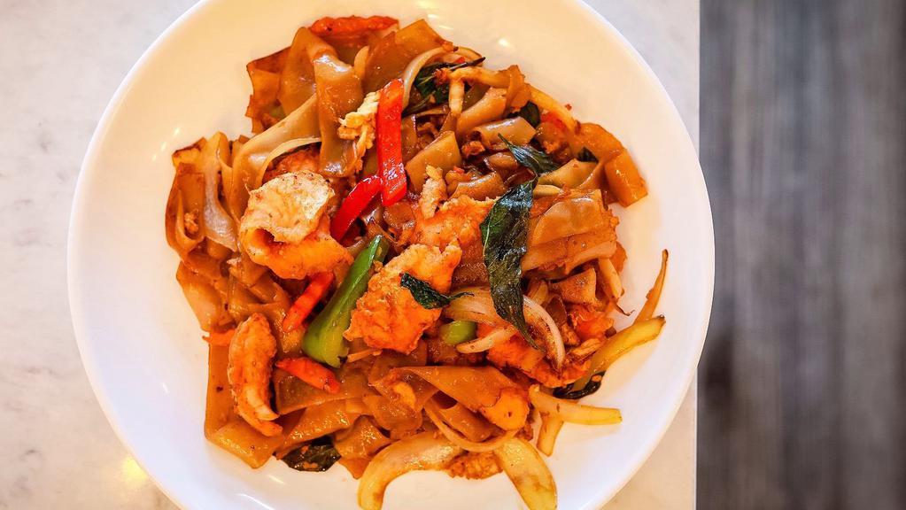 Drunken Noodles · Wide rice noodle sautéed with egg in a mixture of onions, bell peppers, carrots, and fresh basil in our famous chili garlic sauce.