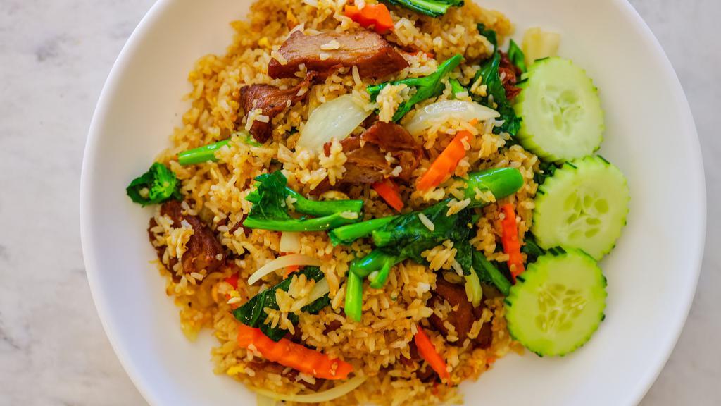 House Fried Rice · Jasmine rice stir fried with egg, Chinese broccoli, onions, and carrots.