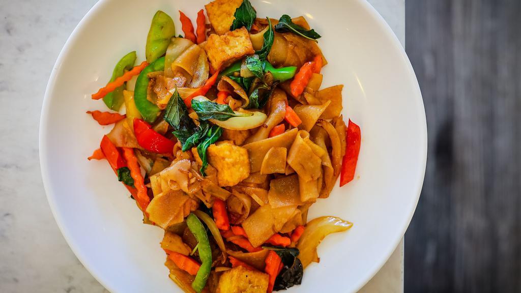 Drunken Noodle  · Wide rice noodle sautéed in a mixture of onions, bell peppers, carrots, and fresh basil in our famous chili garlic sauce.