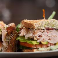 Turkey Club Sandwich · Sandwich with turkey, bacon, fresh lettuce, tomatoes, and mayo on toast.