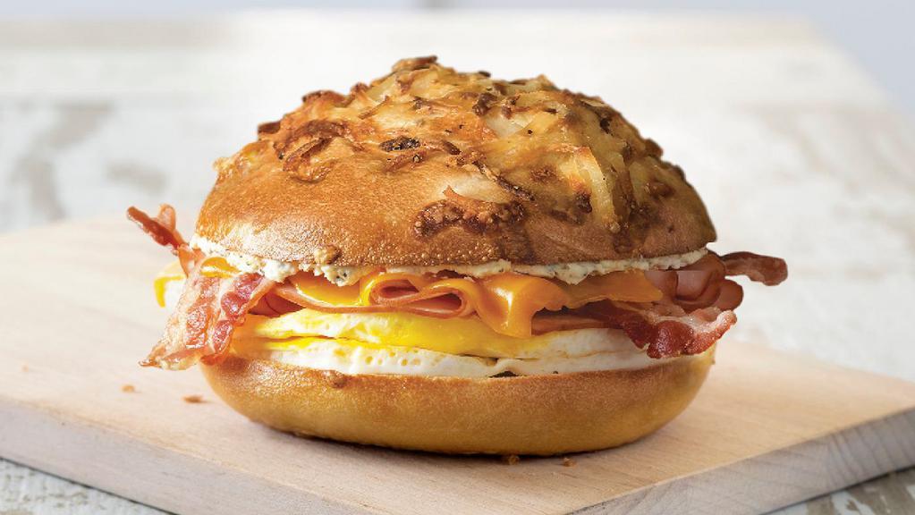 Farmhouse · Farm-inspired and stacked with layers of flavor, the new farmhouse egg sandwich, made with two fresh-cracked eggs, slices of savory peppered bacon, ham, cheddar cheese, and country pepper cream cheese on a toasted cheesy hash brown bagel provides a hearty start to the day.