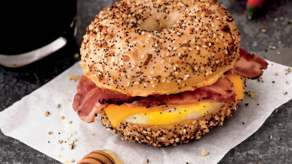 Sriracha Honey Sunrise · Seasoned fresh-cracked egg, peppered bacon, cheddar cheese, and delicious sriracha honey cream cheese on a toasted everything bagel. The sweet heat and creaminess of the cream cheese blends all these flavors together to create a flavor explosion for your taste buds.
