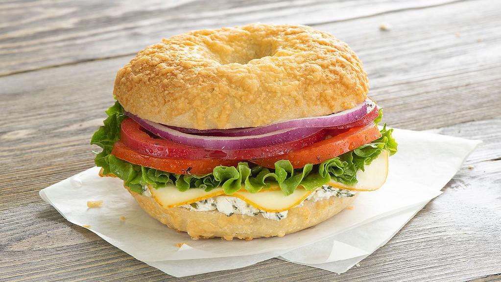 Leonardo Da Veggie · Light herb garlic cream cheese, red peppers, muenster cheese, lettuce, tomato, and red onion on our Asiago bagel.