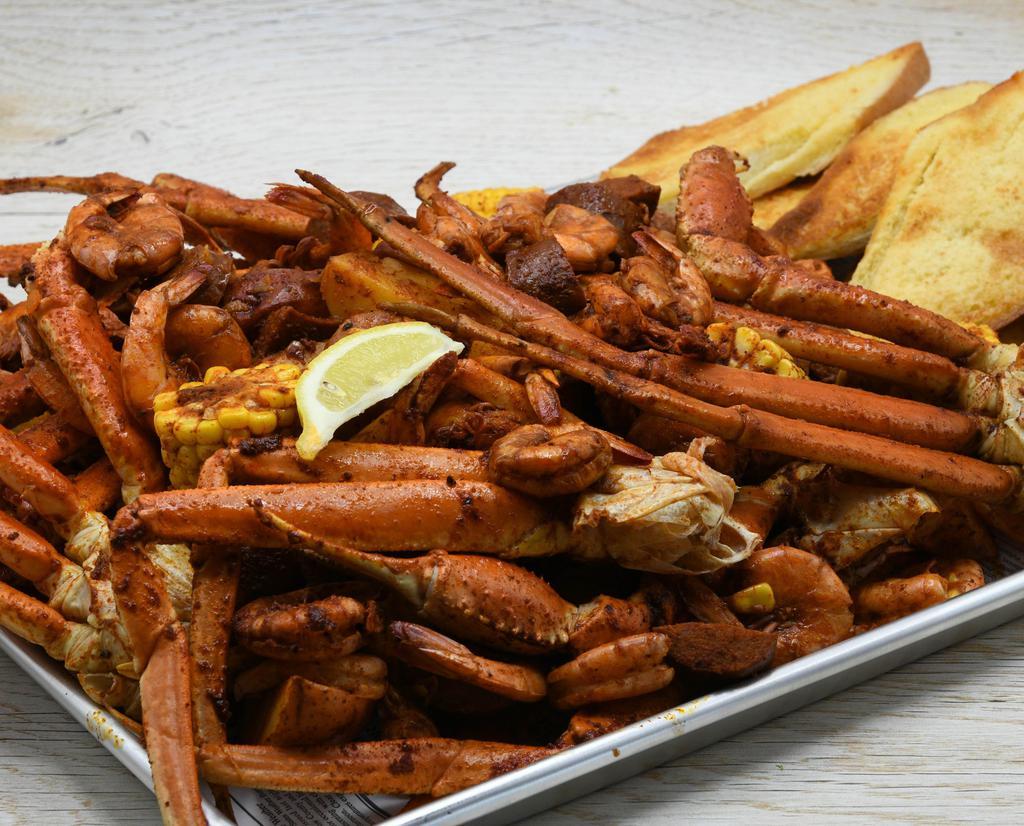 Family Crab And Shrimp Boil · Steamed Crab and Shrimp, Corn, Red Potatoes, Andouille Sausage and Garlic Bread. Choice of Cajun or Garlic.