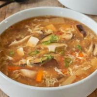 Hot & Sour Soup · Spicy hot & sour soup with egg, peas & carrots, tofu and mushroom.