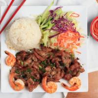 Com Tom Thit · Grilled shrimp and grilled teriyaki pork with steamed rice served with fresh salad & fish sa...
