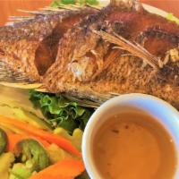 Fried Tilapia · Fried whole tilapia fish tossed with salt & pepper served with steamed rice, pickled salad a...