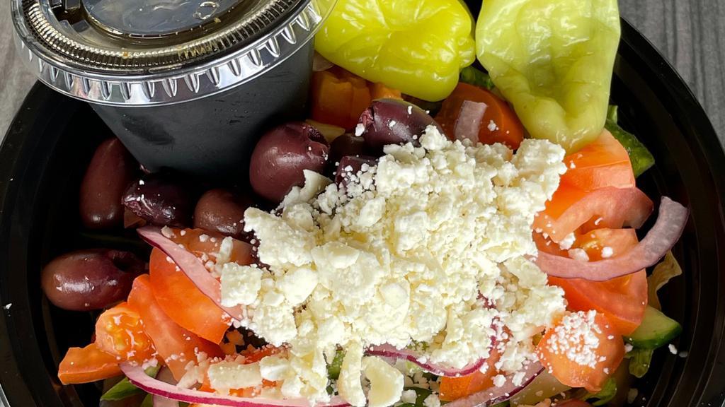 Greek Salad · Romaine spring mix, cucumbers, tomatoes, bell peppers, red onions, kalamata olives and feta cheese tossed with greek dressing.