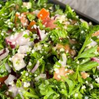 Tabbouleh · Finely chopped parsley, tomatoes, red onions and bulgur tossed with lemon juice and olive oil.