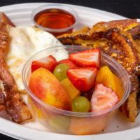 French Toast Combo · 2 french toast triangles, 2 eggs, 2 bacon strips served with fruit.