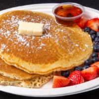 Michelle'S Pancakes · 3 griddle buttermilk pancakes with syrup, butter, and powdered sugar topping with strawberri...