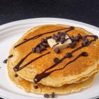 Happy Vegan Pancake · 3 eggless and dairy-free pancakes with syrup and powdered sugar.