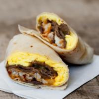 Burrito Tripon · Asada, chorizo, eggs, beans, avocado, cheese.