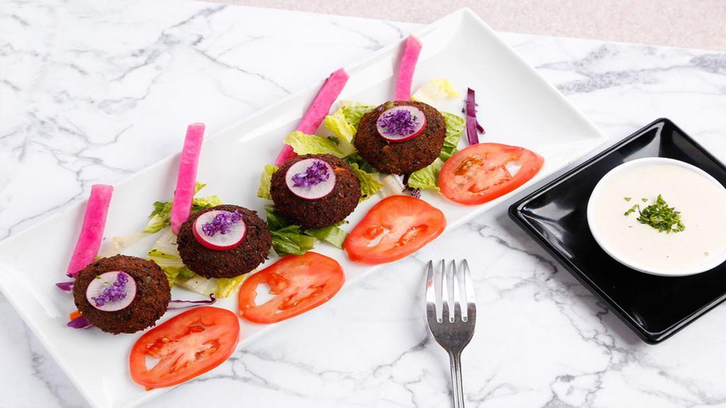 Falafel App · 4 fresh hand made falafels made the from the ground up fresh to order. (Ground and seasoned fava beans and)
served with pita bread, tomato, romaine lettuce and 2 oz. fresh daily made tahini sauce. a vegetarian delight.