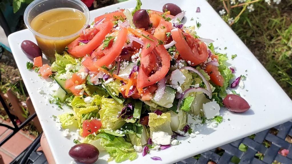 El Greco · Romaine lettuce, Roma tomato, cucumbers, red onions, Kalamata olives and feta cheese. with our balsamic vinegar and extra virgin olive oil base family house dressing. dressing on the side. served with pita.