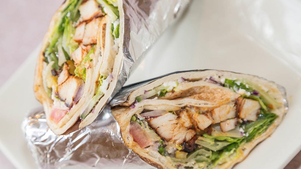 Chicken Kabob Pita Wrap  · chicken pita wrap
Grilled marinated chicken breast chopped up and rolled with hummus, romaine lettuce, tomatoes and seasoned sweet onions.