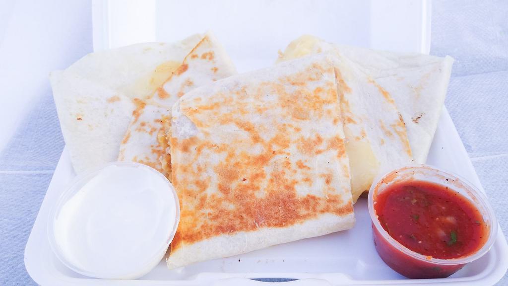Quesadilla · Topped with cheese, sour cream, and lettuce. Filled with your choice of meat.