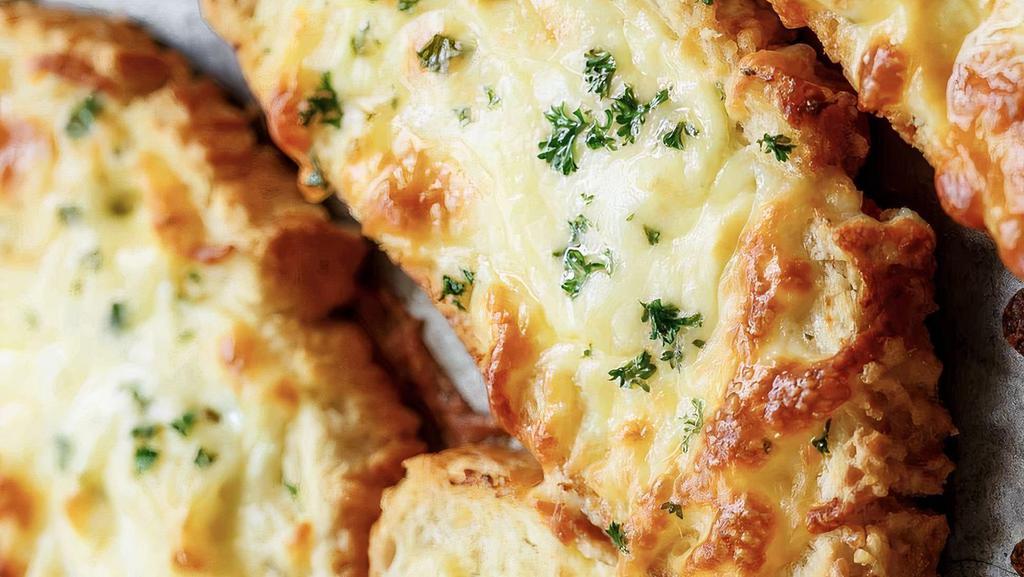 Cheese Garlic Bread · A cross between garlic bread and pizza, cheesy bread is a quick, easy, and delicious party snack.
