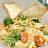 Broccoli Alfredo  · Fettuccine pasta in cream with fresh sautéed broccoli, carrot. Parmesan cheese added on top....