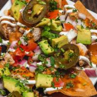 Grilled Chicken Nachos · Black beans, avocado, tomatoes, cilantro, red onions, cheese blend, sliced jalapenos, chipot...