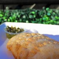 Chicken Empanada Traditional · Olives, bell peppers, onions, beef seasoning, garlic tomato sauce.