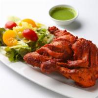 The Tandoori Chicken · The famous chicken marinated in yogurt and mild spices cooked in clay oven.