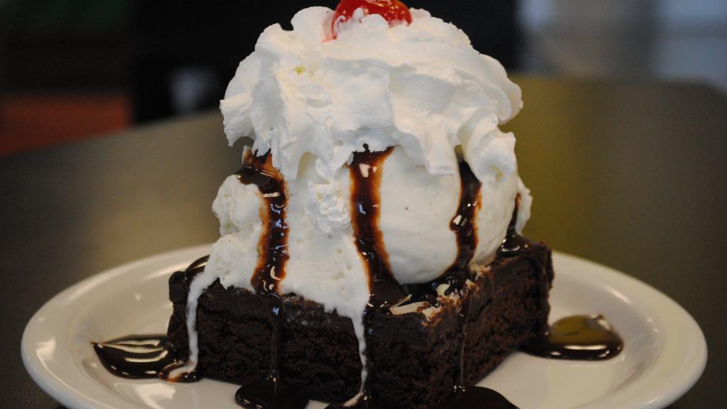 Brownie Sundae · Housemade brownie, vanilla ice cream, Hershey's chocolate, whipped cream and a cherry.