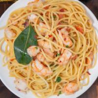 Spicy Wild Shrimp Pasta · Wild shrimp is chopped tomato and white wine garlic sauce.