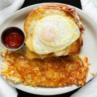 Croque Madame · Classic French ham & cheese sandwich made with grilled sourdough bread, ham, Gouda cheese, a...