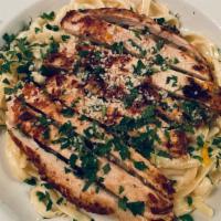 Fettuccine Alfredo With Chicken · Fettuccine tossed with creamy Alfredo sauce and topped with a grilled chicken breast.  Serve...