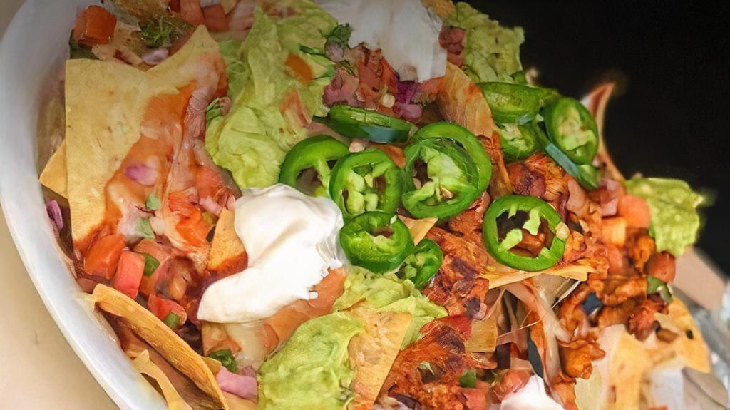 Nachos · Choice of meat: chicken,steak,al pastor and carnitas.