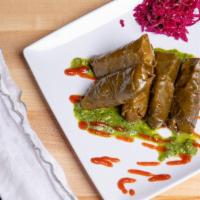 Dolmades · Vine leaves stuffed with basmati rice, herbs and spices. 5 pieces.