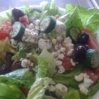 The Greek · Romaine and mixed greens, Roma tomatoes, Feta cheese, kalamata olives, cucumbers, and our ho...