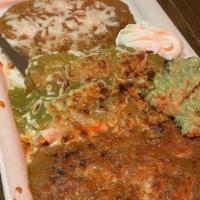Enchiladas De Queso · Two corn tortillas filled with Monterrey Jack cheese topped with our red chile sauce, served...