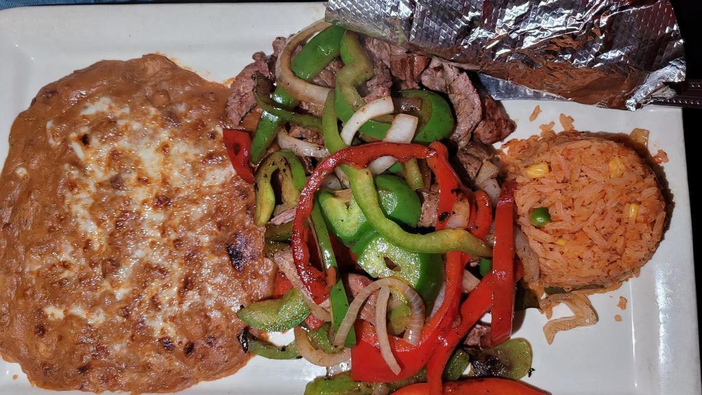Fajitas · Chicken, steak, or shrimp seasoned to perfection and mixed with onions, red & green bell peppers. Served with an Mexican rice, refried beans and Corn or flour tortillas.