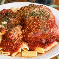 Eggplant Parmigiana · Thinly sliced eggplant breaded, fried & layered with mozzarella cheese then baked. Topped wi...