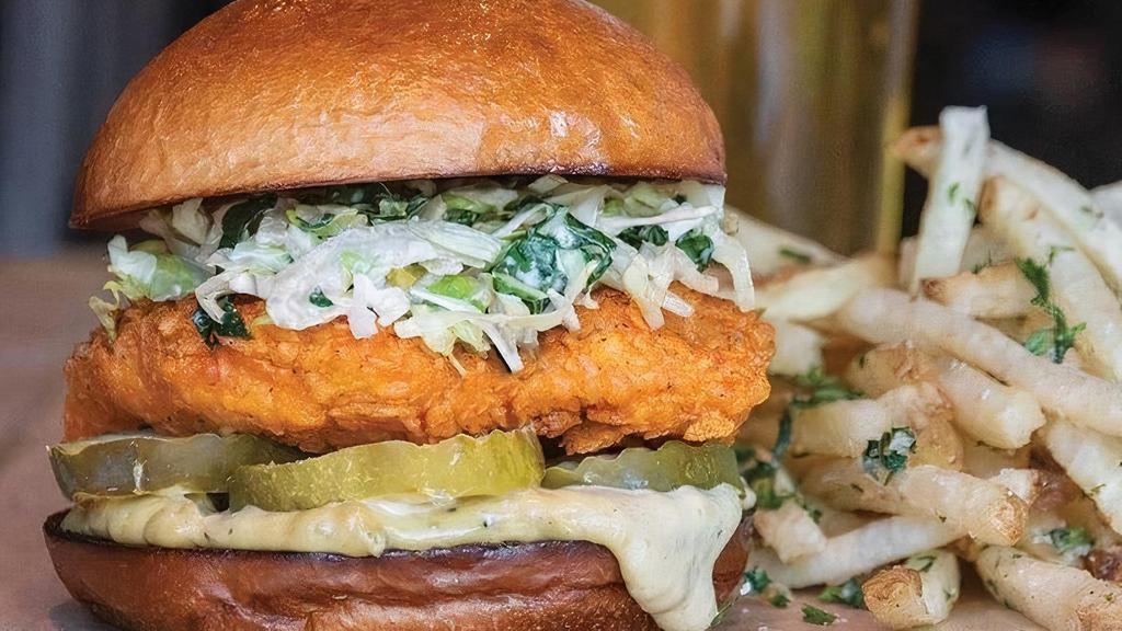 Nashville Hot Chicken Sandwich · Hand-breaded crispy fried chicken dusted with Nashville hot spices and topped with kale cabbage slaw, avocado mayo, Alabama comeback sauce & pickles.