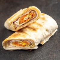 Ham And Cheese Burrito · Fluffy eggs with ham, hash browns, and cheese tucked in a flour tortilla.