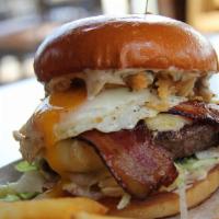 Chophouse Burger · 1/2 lb. angus patty, brioche bun, Welsh cheddar, iceberg, pickle spear, fries egg, truffle, ...