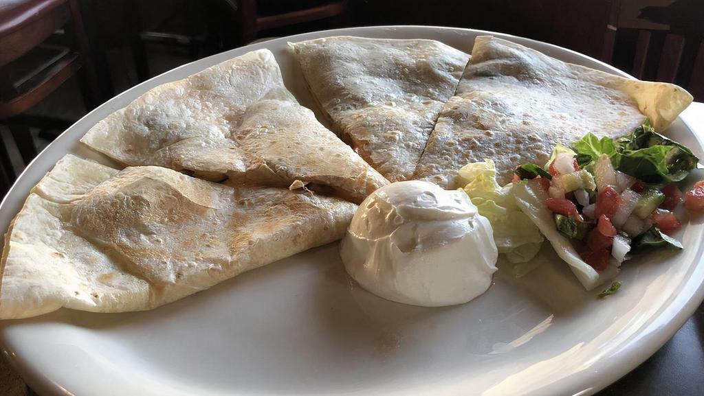 Quesadilla Al Carbon · Our house quesadilla filled with your choice of meat and served with sour cream.