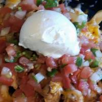 Nachos Fries · French fries topped with cheese, pico De gallo, crema and guacamole.