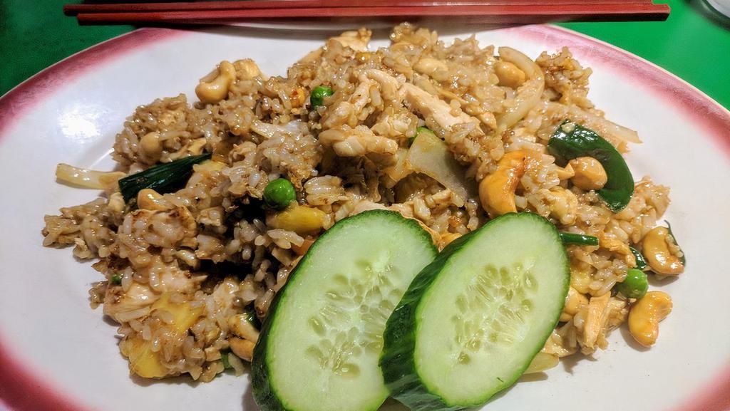 Pineapple Fried Rice · Stir-fried rice with egg, pineapple, cashews, peanuts, onions and diced mixed vegetables.