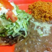 Tostada Plate · Meat, beans, guacamole, salsa, lettuce, sour cream, cheese with  rice, and beans on the side.