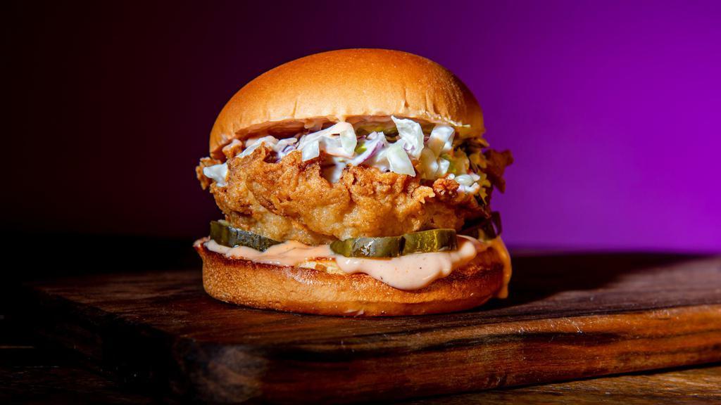 Classic Fried Chicken Sandwich · Southern fried and hand breaded chicken breasts seasoned in our signature New Orleans style spice in between a toasted brioche bun with coleslaw, pickles, classic sauce.