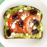 Greek Gooddess Avocado Toast · Avocado toast with tomato, black olives, feta, and olive oil.