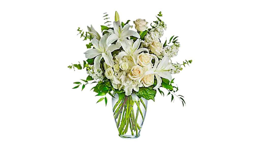 Dreams From The Heart Bouquet · A lovely bouquet to soothe and comfort, a variety of white and peach blossoms sends your hope and strength. Beautifully.
Beautiful flowers such as white hydrangea, spray roses and stock, peach roses, eucalyptus and more fill a tall glass vase