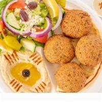 Falafel Plate · Four patties of falafel are served with hummus, salad, and pita bread.