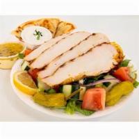 Grilled Chicken Salad Combo · Fresh Greek salad topped with grilled chicken breast with pita bread and tzatziki sauce.